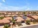 Aerial view of a vibrant community showcasing well-maintained homes, desert landscaping and solar panels at 1771 E Alegria Rd, Queen Creek, AZ 85140