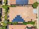 Expansive aerial view of tiled roof adorned with solar panels, complemented by outdoor living spaces and lush landscaping at 1771 E Alegria Rd, Queen Creek, AZ 85140