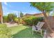 Serene backyard with artificial turf area, lush landscaping, and comfortable seating to enjoy the outdoors at 1771 E Alegria Rd, Queen Creek, AZ 85140