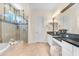Elegant bathroom with a glass-enclosed shower, soaking tub, and double vanity with black countertops at 1771 E Alegria Rd, Queen Creek, AZ 85140