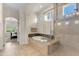 Bright bathroom with a frameless shower, soaking tub, dual sinks, and natural light from the window at 1771 E Alegria Rd, Queen Creek, AZ 85140