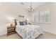 Cozy bedroom featuring a patterned quilt, chandelier, and shuttered windows with natural light at 1771 E Alegria Rd, Queen Creek, AZ 85140
