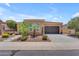 Charming single-story home with a well-maintained front yard, desert landscaping and a two-car garage at 1771 E Alegria Rd, Queen Creek, AZ 85140