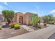 Inviting single-story home with desert landscaping, flowering shrubs, and charming covered entry at 1771 E Alegria Rd, Queen Creek, AZ 85140