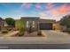 Attractive single-story home with a well-manicured front yard, desert landscaping, and a two-car garage at dusk at 1771 E Alegria Rd, Queen Creek, AZ 85140