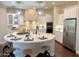 Bright kitchen features white cabinets, stainless steel appliances, and quartz countertops with pendant lighting at 1771 E Alegria Rd, Queen Creek, AZ 85140