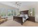 Spacious main bedroom with a ceiling fan, plush carpet, large windows and a king-size bed at 1771 E Alegria Rd, Queen Creek, AZ 85140