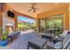 Outdoor patio with fireplace, ceiling fan, and comfortable seating, perfect for entertaining at 1771 E Alegria Rd, Queen Creek, AZ 85140