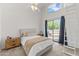 Bright bedroom with vaulted ceilings, a ceiling fan, and access to an outdoor balcony at 1800 W Elliot Rd # 240, Chandler, AZ 85224