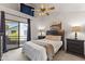 Bright bedroom with a ceiling fan, a sliding glass door leading to a balcony, and ample closet space at 1800 W Elliot Rd # 240, Chandler, AZ 85224