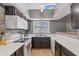 Well-lit kitchen with dark cabinets, modern appliances, and plenty of counter space at 1800 W Elliot Rd # 240, Chandler, AZ 85224