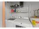 Laundry room with a side by side washer and dryer, shelving, and water heater at 1800 W Elliot Rd # 240, Chandler, AZ 85224