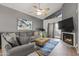 Comfortable living room with a fireplace, hardwood floors, and lots of natural light at 1800 W Elliot Rd # 240, Chandler, AZ 85224
