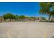 Full-sized basketball court within the community surrounded by manicured landscaping and residential homes at 1836 N 77Th Gln, Phoenix, AZ 85035