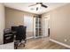 Functional bedroom setup with a desk, shelves, and light-colored wood flooring at 1836 N 77Th Gln, Phoenix, AZ 85035