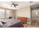 Neutral bedroom with ceiling fan, wood flooring, and a view of the exterior at 1836 N 77Th Gln, Phoenix, AZ 85035