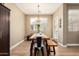 Cozy dining room with a wooden table, bench seating, and a decorative light fixture at 1836 N 77Th Gln, Phoenix, AZ 85035