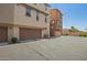 Tan home featuring dual garage doors and back alley access at 1836 N 77Th Gln, Phoenix, AZ 85035