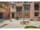 Charming multi-level townhome with a well-maintained walkway and front patio at 1836 N 77Th Gln, Phoenix, AZ 85035