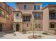 Charming multi-level townhome with a well-maintained walkway and front patio at 1836 N 77Th Gln, Phoenix, AZ 85035