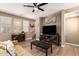 Open-concept living room with wood flooring, a ceiling fan, and a wall-mounted TV at 1836 N 77Th Gln, Phoenix, AZ 85035