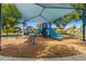 A well-maintained community playground area with various play structures and shaded seating at 1836 N 77Th Gln, Phoenix, AZ 85035