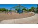 Community playground featuring slides and swings with protective ground cover, providing safe outdoor play at 1836 N 77Th Gln, Phoenix, AZ 85035
