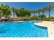 Gorgeous community pool with a splash pad, surrounded by mature landscaping and seating areas at 1836 N 77Th Gln, Phoenix, AZ 85035