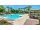 A sparkling community pool featuring a splash zone, inviting cabana, and surrounded by mature trees at 1836 N 77Th Gln, Phoenix, AZ 85035