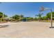 Well-appointed outdoor recreation space with basketball court, playground, shaded seating, and lush landscaping at 1836 N 77Th Gln, Phoenix, AZ 85035