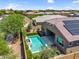 Aerial view of the backyard with a sparkling pool, solar panels, and well-manicured landscaping at 21352 E Domingo Rd, Queen Creek, AZ 85142