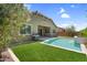View of backyard featuring a pool, artificial grass and a built in barbecue grill at 21352 E Domingo Rd, Queen Creek, AZ 85142