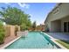 Backyard featuring a swimming pool with a waterfall and a built in barbecue grill at 21352 E Domingo Rd, Queen Creek, AZ 85142