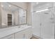 Well-lit bathroom with white vanity, framed mirror, and a frameless glass shower with a rainfall shower head at 21352 E Domingo Rd, Queen Creek, AZ 85142