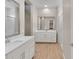 Elegant bathroom boasts double vanities with white countertops, large mirrors, and a walk-in shower at 21352 E Domingo Rd, Queen Creek, AZ 85142