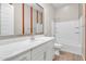 Stylish bathroom with white vanity, framed mirror, and a tub-shower combination with white tile surround at 21352 E Domingo Rd, Queen Creek, AZ 85142