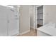 Modern bathroom with a glass-enclosed shower, white vanity, and walk-in closet access at 21352 E Domingo Rd, Queen Creek, AZ 85142