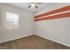 Comfortable bedroom features natural light, carpet flooring, and an accent wall at 21352 E Domingo Rd, Queen Creek, AZ 85142