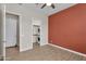 Bedroom with wood look tile floors, closet with stackable washer and dryer at 21352 E Domingo Rd, Queen Creek, AZ 85142
