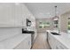 Bright kitchen features white cabinetry, stainless steel appliances, and an island with bar seating at 21352 E Domingo Rd, Queen Creek, AZ 85142