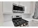 Close-up of the kitchen featuring a stainless steel oven, gas range, and white subway tile backsplash at 21352 E Domingo Rd, Queen Creek, AZ 85142