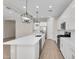 Bright kitchen with modern pendant lighting, stainless steel appliances, and a spacious quartz countertop at 21352 E Domingo Rd, Queen Creek, AZ 85142