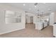Bright open-concept living space with hardwood floors, modern lighting, and a seamless transition to the kitchen area at 21352 E Domingo Rd, Queen Creek, AZ 85142