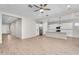 Open-concept living space with modern finishes, light-colored wood floors, and a seamless transition to the kitchen at 21352 E Domingo Rd, Queen Creek, AZ 85142