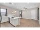Open concept room featuring stylish lighting, wood-look flooring, and a modern kitchen with stainless steel appliances at 21352 E Domingo Rd, Queen Creek, AZ 85142