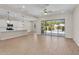 Open-concept living space with modern finishes, light-colored wood floors, and access to the outdoor pool area at 21352 E Domingo Rd, Queen Creek, AZ 85142