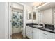 Well-lit bathroom featuring a shower/tub and vanity with a black countertop at 2228 N 52Nd St # 140, Phoenix, AZ 85008