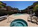 Community pool and spa with tables and chairs at 2228 N 52Nd St # 140, Phoenix, AZ 85008