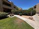 A quaint courtyard with lush green grass and charming bench seating, complemented by well-maintained landscaping at 2228 N 52Nd St # 140, Phoenix, AZ 85008