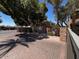 Community front entrance with a brick drive and beautiful mature shade trees at 2228 N 52Nd St # 140, Phoenix, AZ 85008